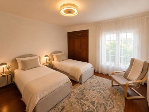 Bright twin bedroom at Casa Forever Young villa in Sesimbra with garden views, wooden wardrobe, and modern ceiling fan