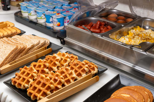 Buffet petit-déjeuner de l'Hôtel Royal Paris Ivry avec gaufres, pain, yaourt et légumes frais