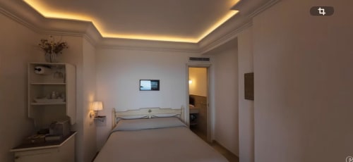 Modern bedroom at Villa D Alessandro in Anacapri with ambient ceiling lighting, flat-screen TV, and direct access to private