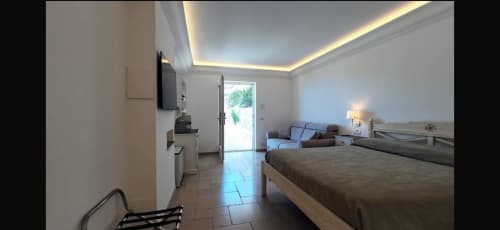 Spacious apartment bedroom in Villa D'Alessandro, Anacapri, with sea view, modern amenities, and private jacuzzi access