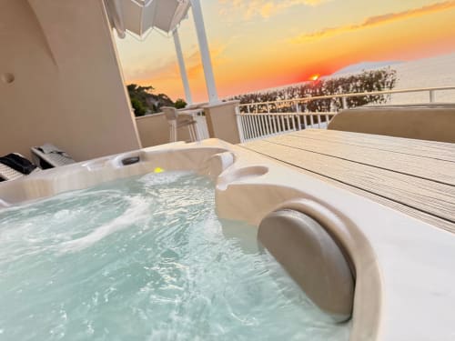 Private jacuzzi on balcony at Villa D Alessandro Anacapri with sunset sea view over Capri island