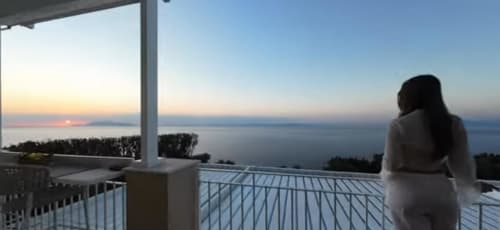 Woman enjoying sunset sea view from terrace at Villa D'Alessandro, Anacapri, Italy