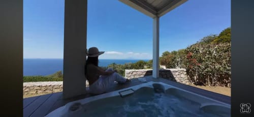 Guest relaxing in private hot jacuzzi overlooking the sea at Villa D'Alessandro, Anacapri
