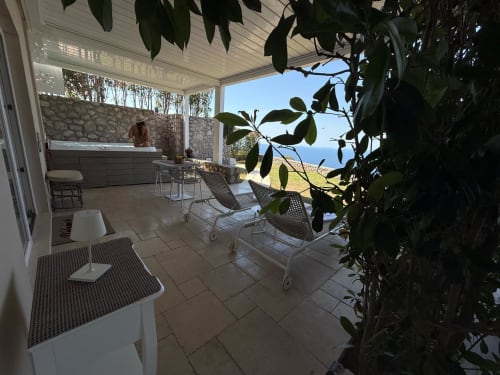 Private apartment terrace at Villa D'Alessandro in Anacapri with jacuzzi, sea views, and Mediterranean vegetation