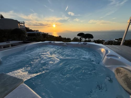 Hot jacuzzi on terrace with sunset sea view over Anacapri, Italy at Villa D Alessandro