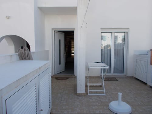 Casa Dourada villa bedroom with white furniture, sea view doors, and private patio in Aljezur, Portugal