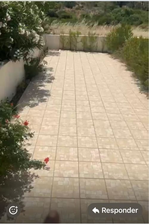Beige tiled patio at Casa Dourada villa in Aljezur with lush greenery and private garden space