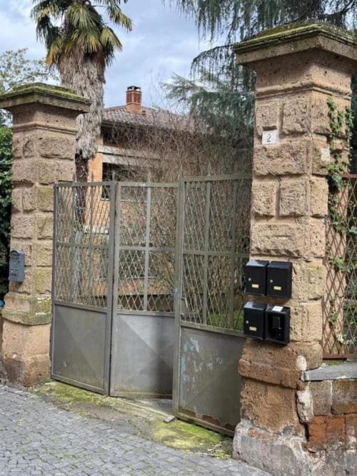 Cancellate d'ingresso in pietra con porta a rete metallica presso Il Giardinetto di Elelú B&B a Orvieto, Italia