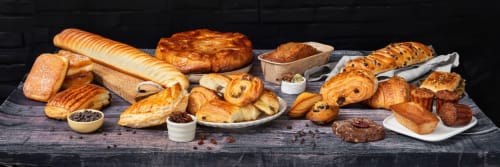 Artisan bakery display with French pastries, croissants, and bread at Clos Céleste Ecrainville B&B breakfast service