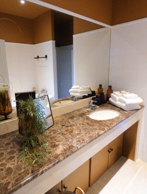 Luxury bathroom at Les Rives De La Tronne with granite countertop, double sink, and spa amenities