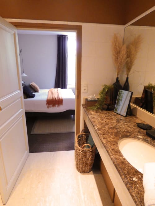 La Chambre Safran bathroom at Les Rives De La Tronne with vanity, sink, and view into bedroom
