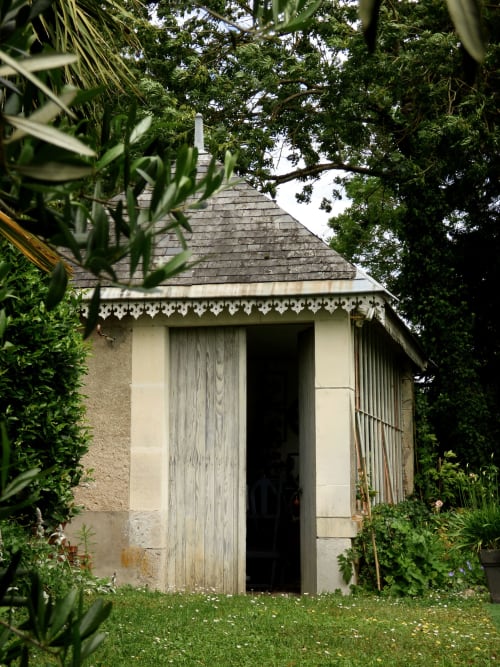 Charming stone garden cottage at Les Rives De La Tronne, Mer, France, surrounded by lush greenery