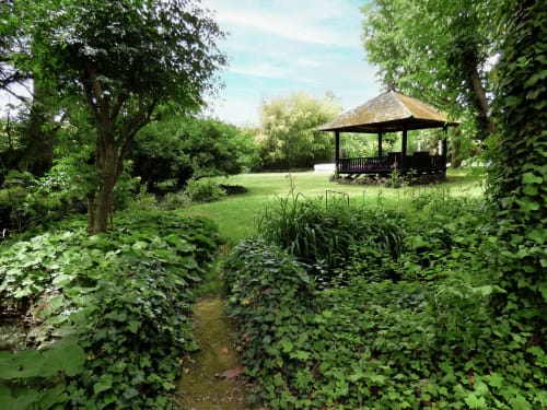 Lush garden with pavilion at Les Rives De La Tronne hotel in Mer, France