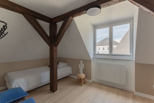 Modern bedroom in Le JO·LIE Duplex, Colmar with exposed beams, single bed, and landmark views