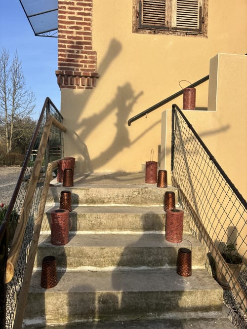 Escalier avec jardinières cylindriques rouges menant à l'entrée jaune du bâtiment au Domaine du Pin, Romans en France