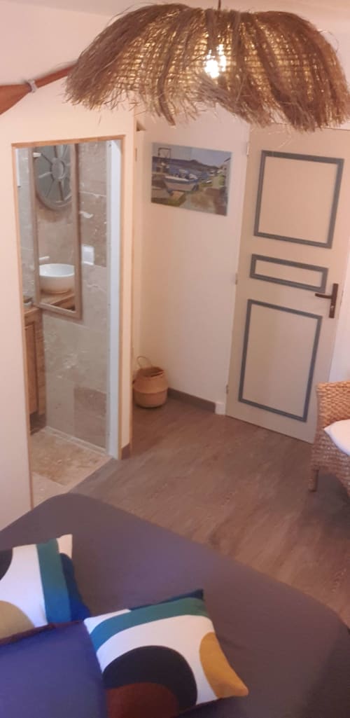 Chambre L'espiguette à l'hôtel Vesta Gaia à Saint-Gilles avec douche, luminaire suspendu tissé et décoration moderne