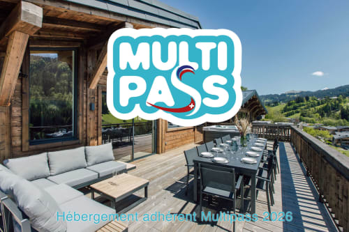 Chalet Magy's mountain-view terrace in Les Gets with dining setup and lounge seating