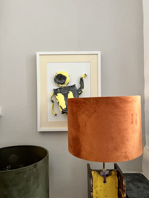Framed yellow and black abstract artwork beside terracotta lamp at Hôtel La Suite, Villeneuve-lès-Avignon