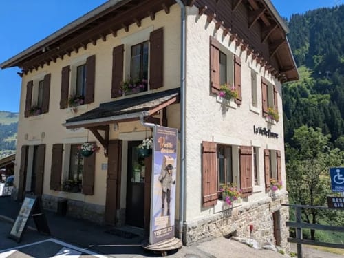 Hôtel Les Triolets exterior in Châtel with cream and brown Alpine architecture, mountain backdrop