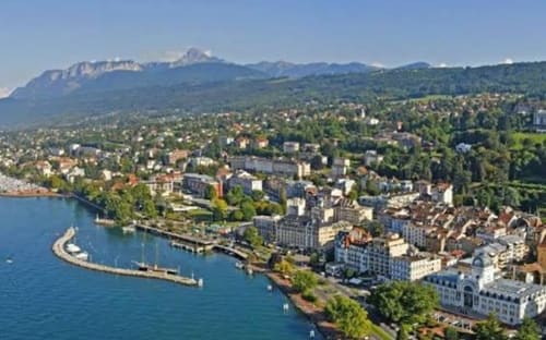 Aerial view of Montreux, Switzerland with alpine mountains and lakefront cityscape near Hôtel Les Triolets in Châtel