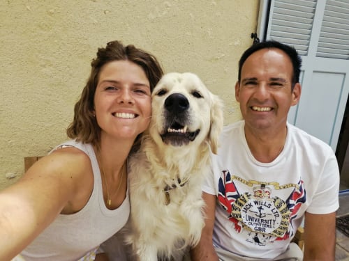 Two guests smiling with white dog at Casa Pertica, a bed and breakfast in Ceton, France