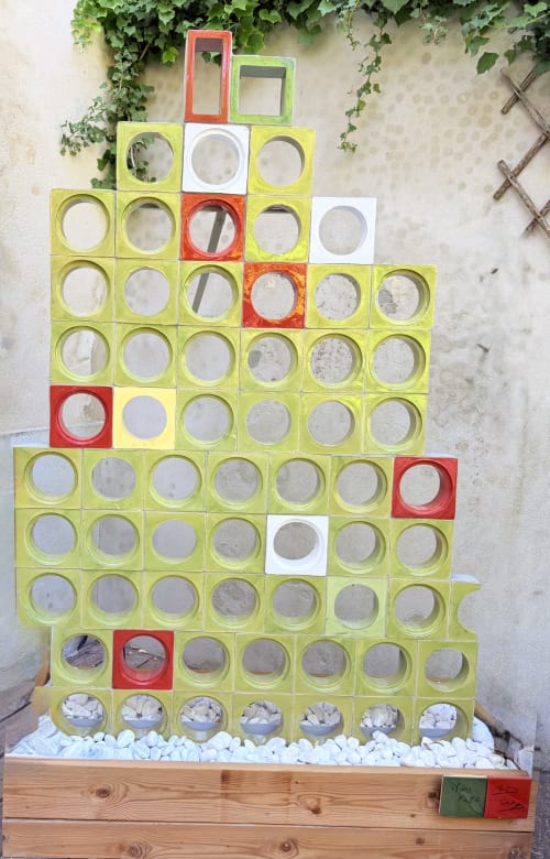 Colorful modular wall sculpture with circular openings at Hôtel La Suite, Villeneuve-lès-Avignon