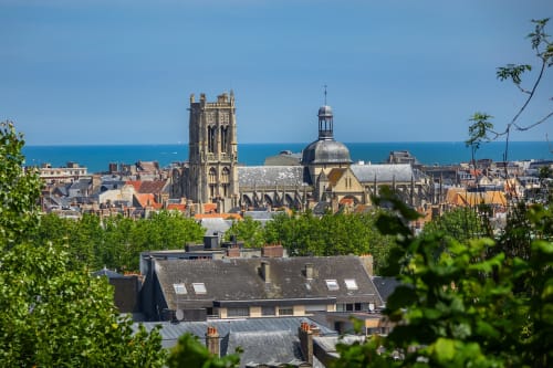 Skol In Normandy hotel overlooks historic coastal town with Gothic cathedral and blue sea views