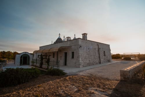 Esterno dell'hotel Trulli Life a Ostuni, Italia - tradizionale edificio in pietra con tetto conico e ingresso ad arco