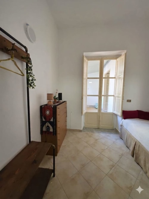 Camera luminosa al Mappamondi BnB di Venezia con letti gemelli, comò in legno e porte-finestre che si aprono sul balcone