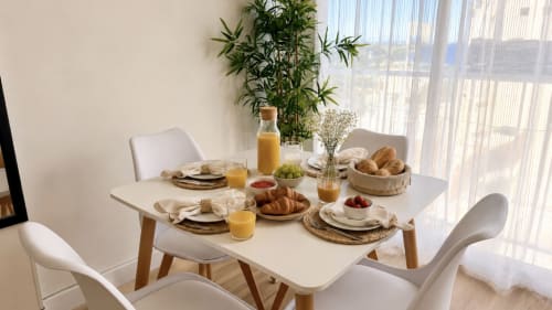 Mesa elegante del desayuno en apartamento Karina 6C de Holidays Costa Brava con pastelería, zumo y vista al río