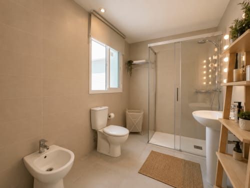 Modern bathroom with shower, toilet, bidet and pedestal sink at Living Sur apartment, Sanlúcar de Barrameda