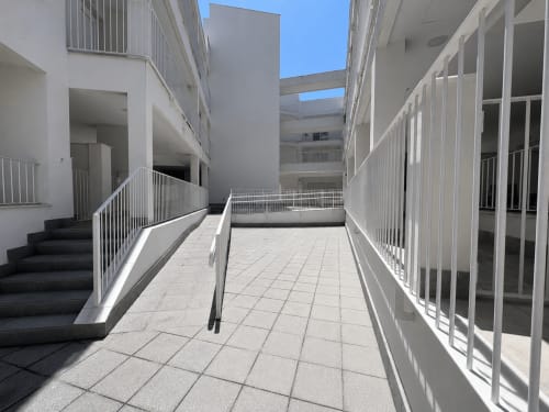 Modern apartment building walkway at Living Sur, Sanlúcar de Barrameda with white railings and terrace access