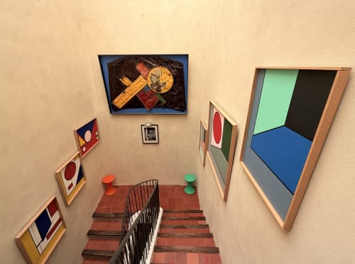 Colorful modern artworks displayed on stairwell walls at Hôtel La Suite in Villeneuve-lès-Avignon