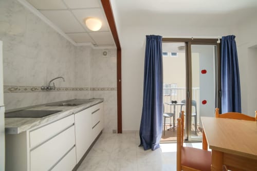 Cocina y comedor en Apartamentos Playa Sol en Es Canar con electrodomésticos modernos y acceso a balcón