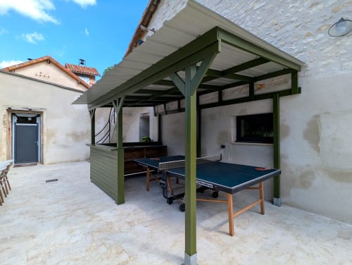 Pergola verte avec table de ping-pong dans la cour du Domaine Alga, gîte à Bourg-Charente