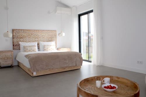 Modern bedroom at Casa Mareta villa in Bordeira with wooden patterned headboard, sea view, and minimalist décor