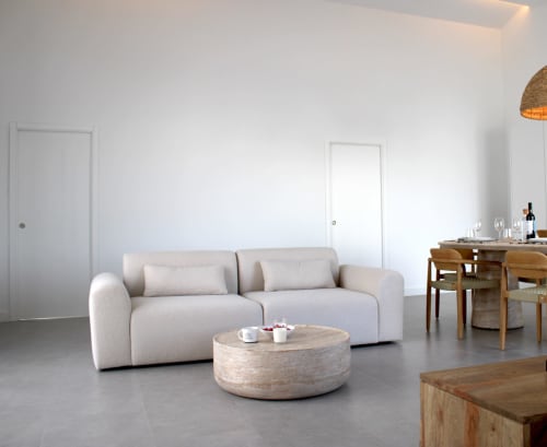 Modern living room at Casa Mareta villa with beige sofa, wooden coffee table, dining area, and white doors in Bordeira,