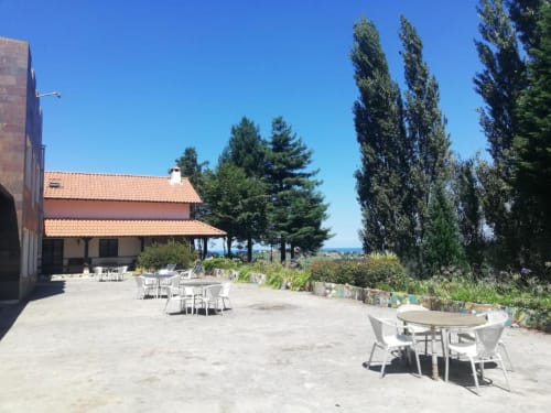 Terrace seating at Posada Torre del Milano with views over Comillas, Spain on a clear day