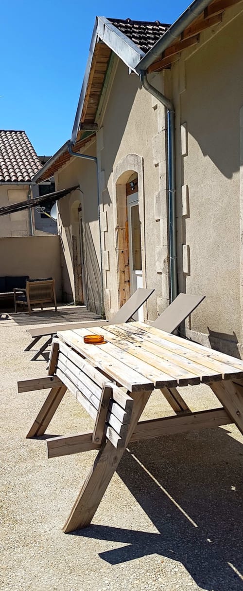 Construction work table in courtyard at Domaine Alga B&B, Bourg-Charente, with stone buildings