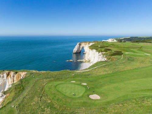 Golf hole overlooking white cliffs and turquoise sea near Étretat, Normandy, France at Clos Céleste