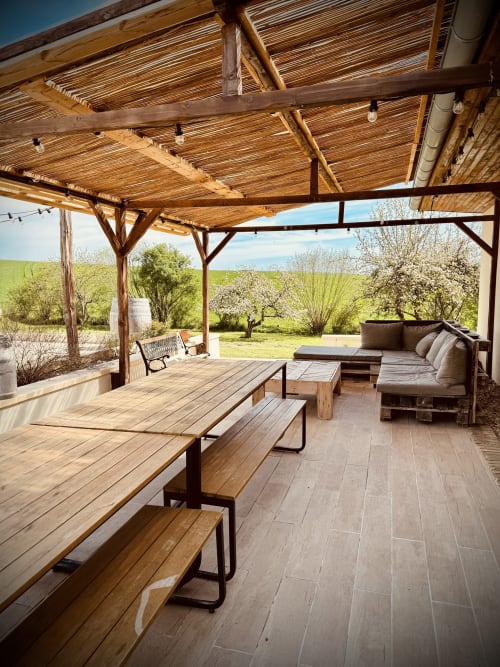 Pergola en bois avec coin repas et salon overlooking verdoyants jardins à la villa Maison Héléna à Lain, France