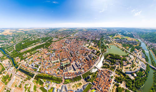Aerial view of Seingbouse, France showing medieval old town with red-roofed buildings and surrounding rivers