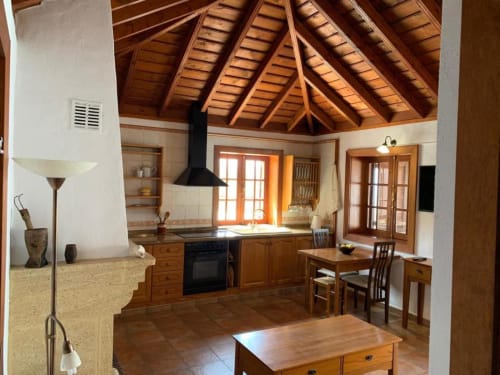 Amplia cocina de villa con vigas de madera vista, comedor y terraza en Rural La Palma, El Pinillo
