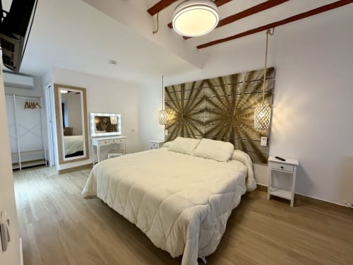 Modern bedroom at Complejo Turístico Retiro del Teatro in Almagro with queen bed, city views, wood beams, and contemporary