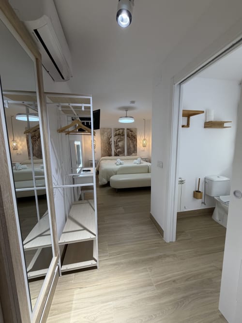 Modern hotel room at Complejo Turístico Retiro del Teatro in Almagro with beds, bathroom, and city views