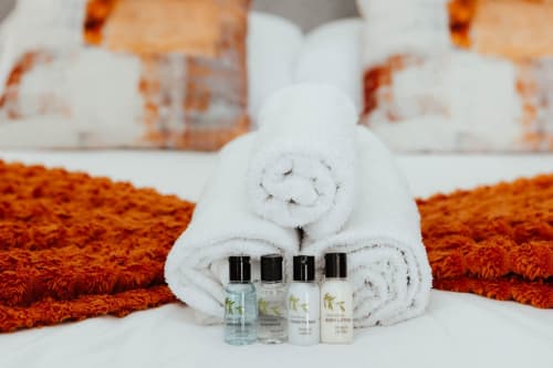 Rolled white towels with toiletries at JS Apartments Collection in Blackburn, UK hospitality suite
