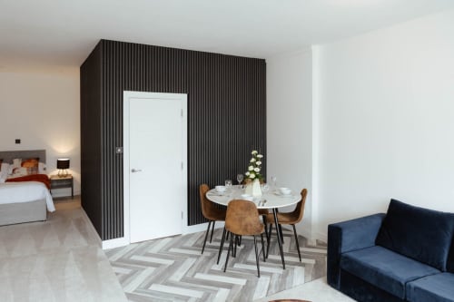 The Spacious Suite at JS Apartments, Blackburn - modern open-plan apartment with dining area, sofa, and bedroom