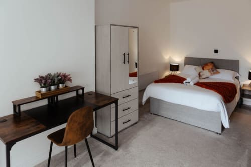 Spacious Suite at JS Apartments, Blackburn: modern bedroom with desk, wardrobe, and contemporary furnishings