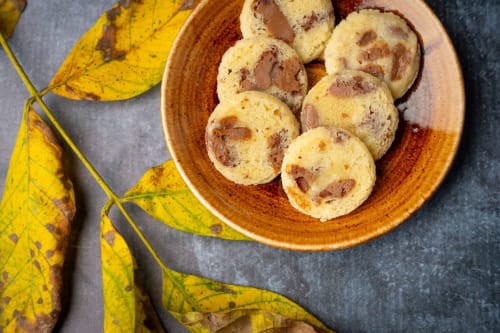 Homemade cookies with nuts on rustic plate, autumn leaves beside, Hôtel Restaurant Le S'Y