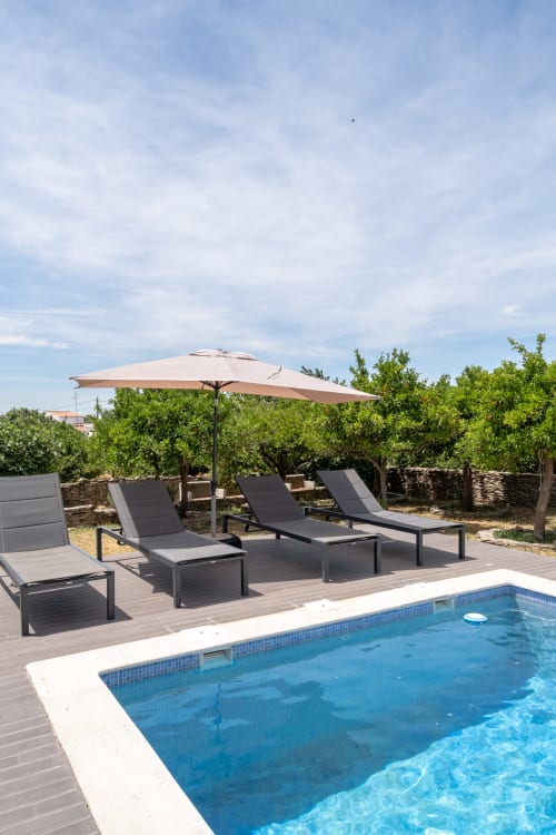 Piscina com espreguiçadeiras e guarda-sol da vila Casa do Loureiro em Alandroal, Portugal